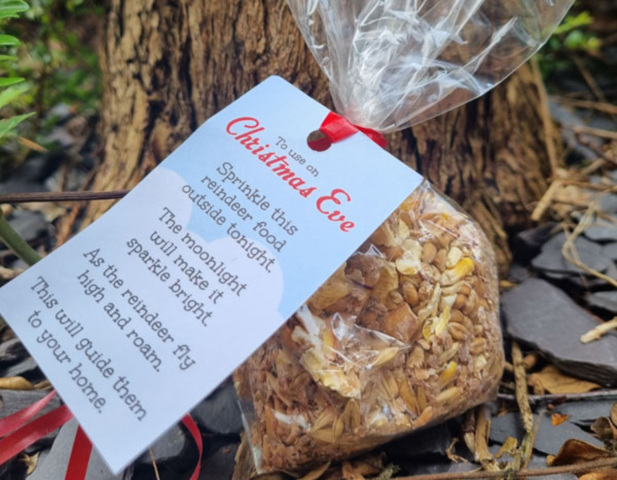 Image of Linen reindeer food in a plastic bag with a paper tag attached to it with a Christmas poem