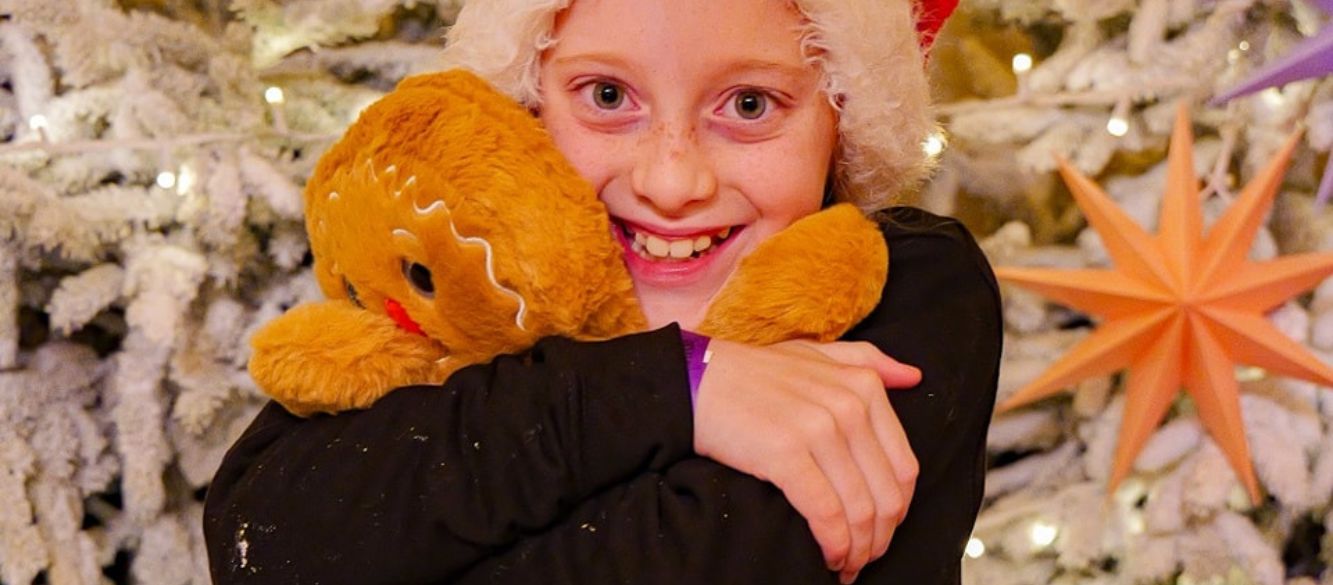 Cute girl hugging her Build-a-Bear toy at the Cuddle Corner at Bluebell Dairy
