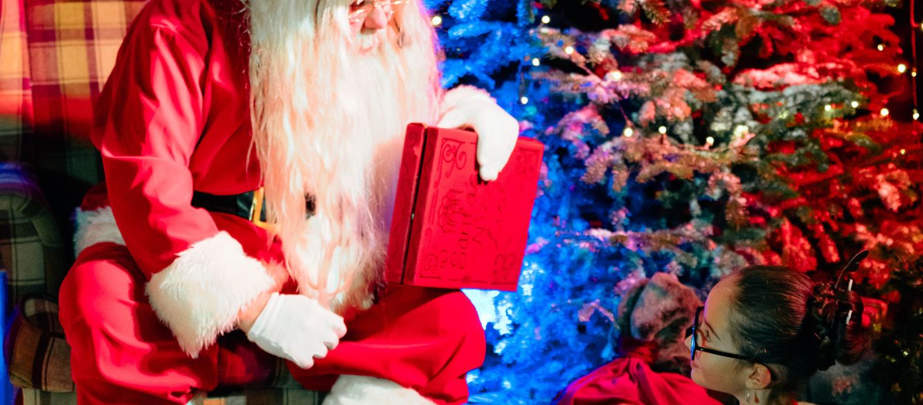 Child sharing a special moment with Santa at Bluebell Dairy's Christmas event